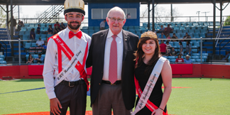 President Morgan poses with the Homecoming King and Queen.