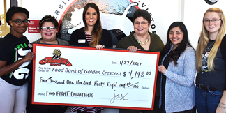 Students present check from Food Fight donations to the Food Bank of the Golden Crescent