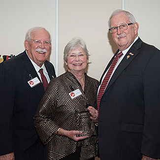 Will Armstrong, left, Linda Armstrong, center, President Vic Morgan, right