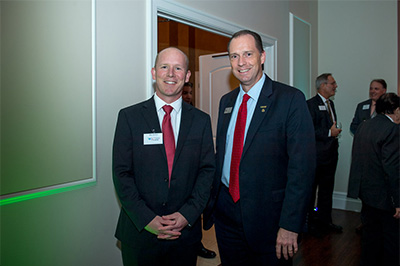 Jesse D. Pisors, Vice President for Advancement and External Relations, standing with a donor