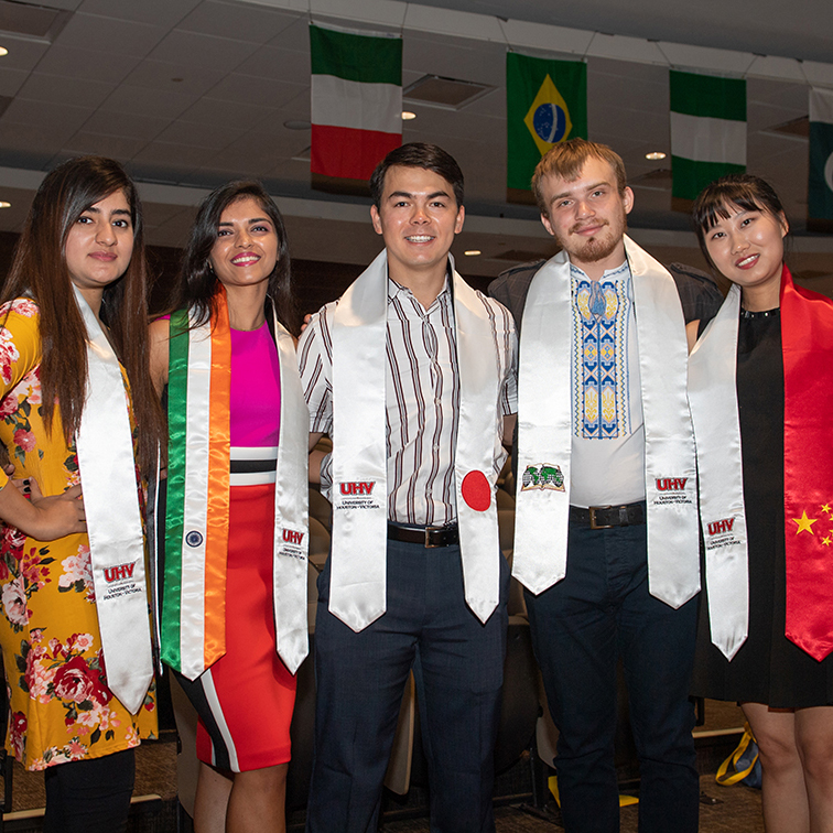 international students posing with graduation regalia